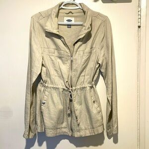 Tan spring zip up jacket with waist drawstring.